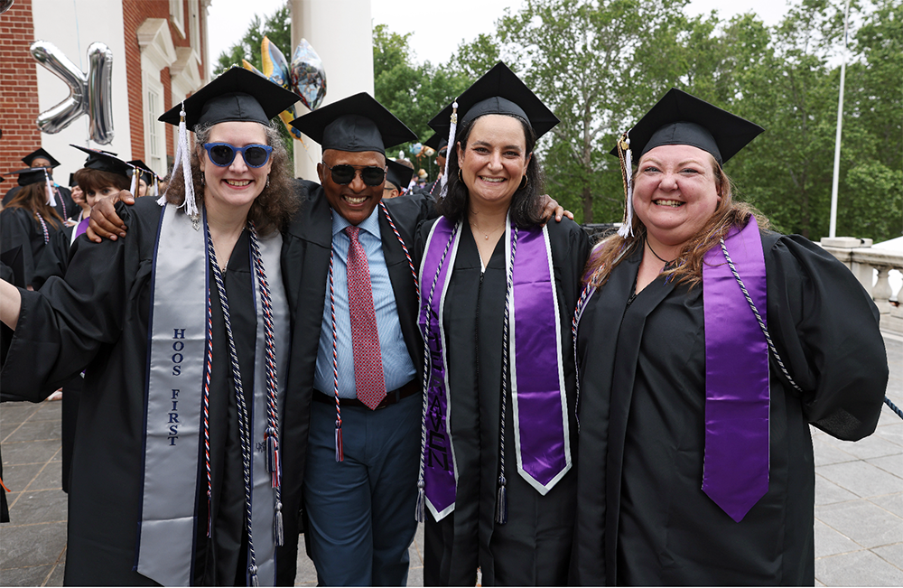 Four BIS graduates at UVA Rotunda