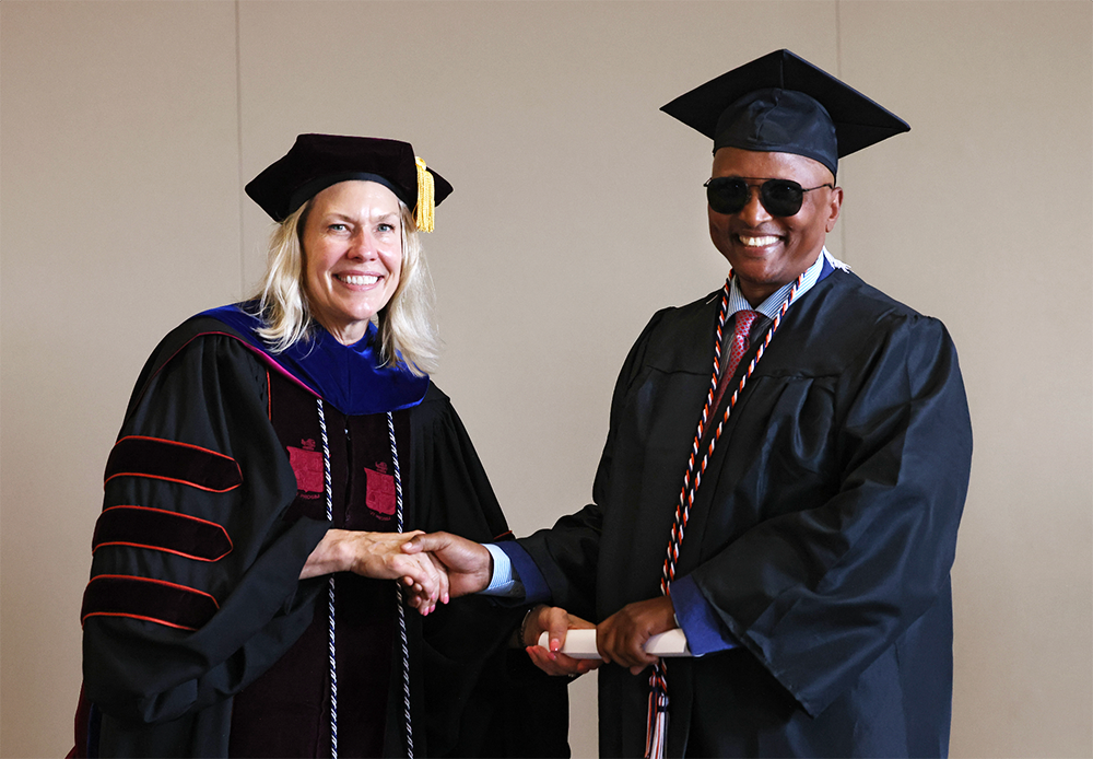 Rugumayo receives diploma from UVA Dean Lubin